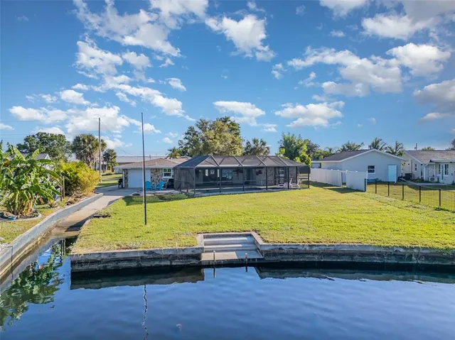 a view of swimming pool with outdoor seating and yard