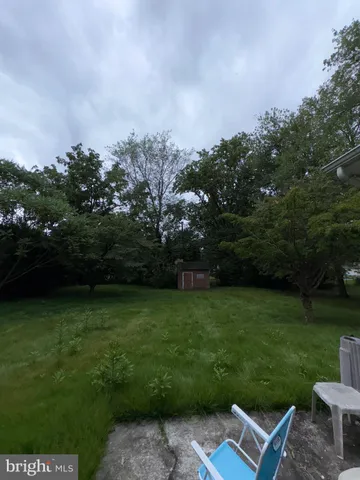 a view of a chair and table on the garden