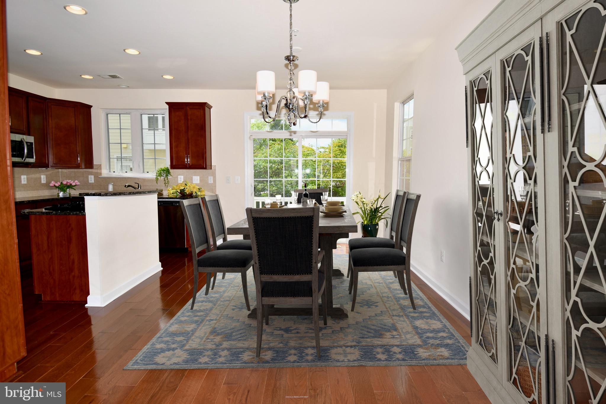 11665 Leesborough Circle Silver Spring, MD 20902 - Photo 2 of 82 a dining room with wooden floor a chandelier a wooden table and chairs