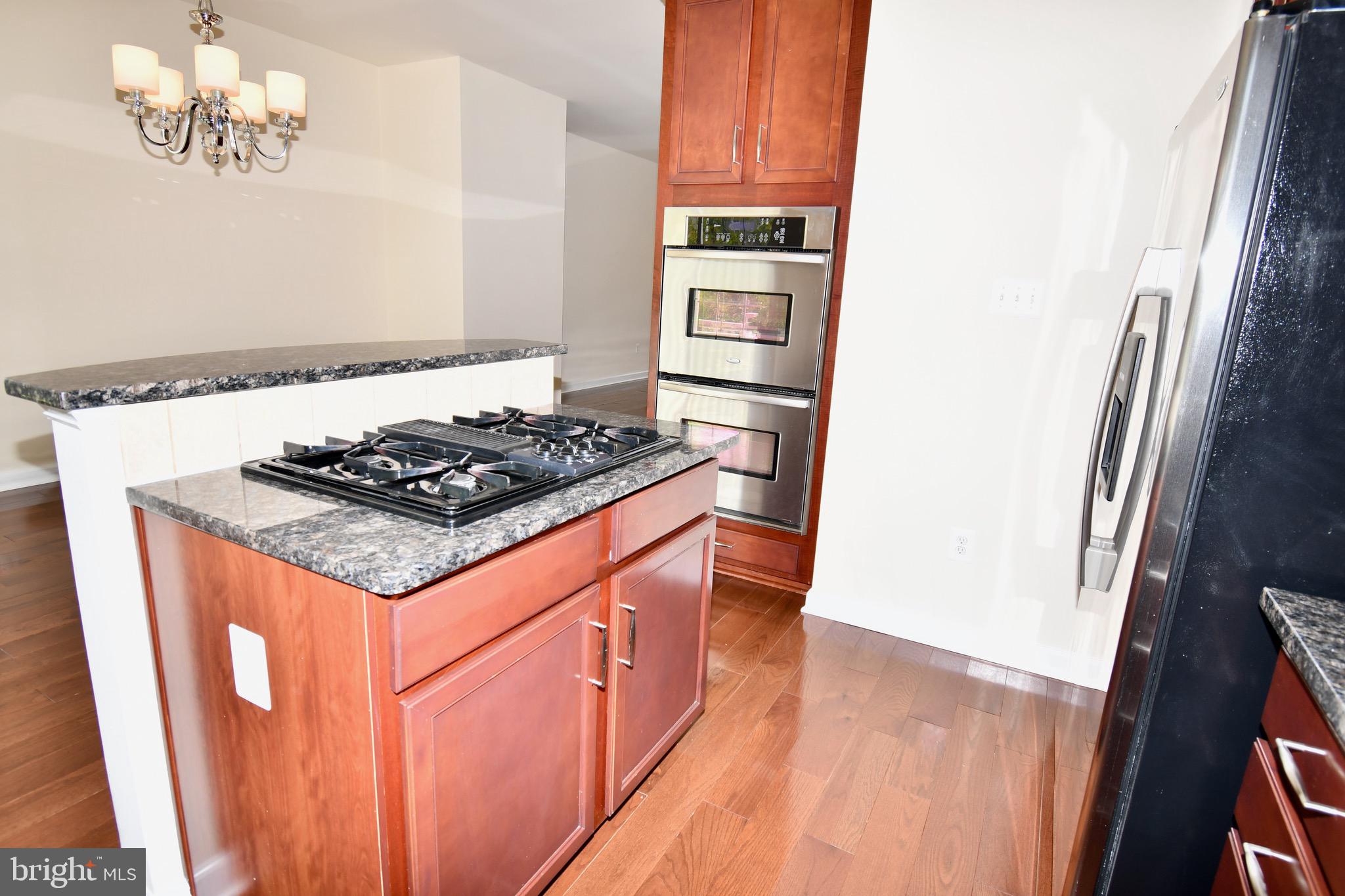 11665 Leesborough Circle Silver Spring, MD 20902 - Photo 23 of 82 a kitchen with stainless steel appliances granite countertop a sink stove and refrigerator
