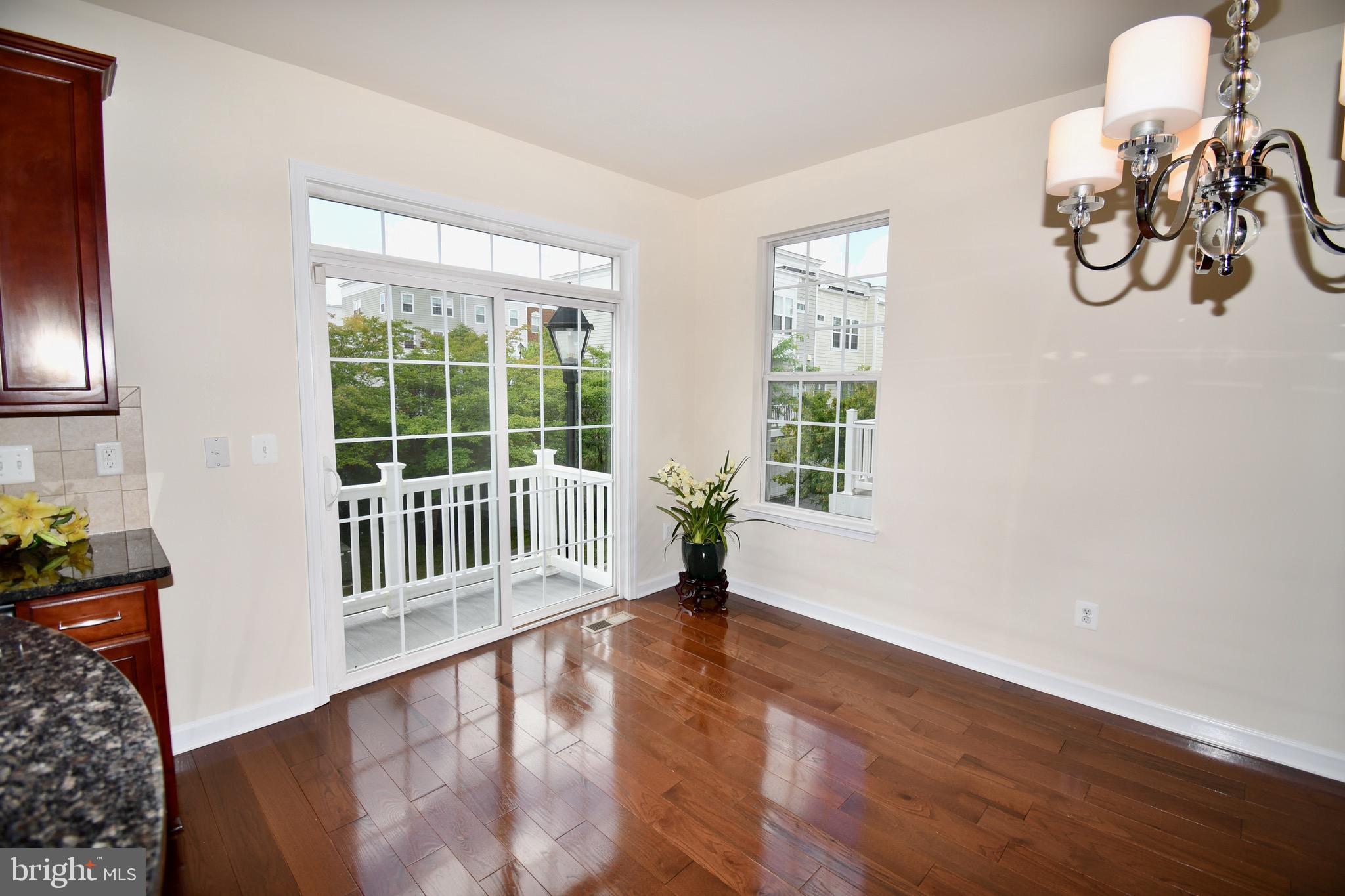 11665 Leesborough Circle Silver Spring, MD 20902 - Photo 25 of 82 a view of a room with wooden floor windows and a chandelier