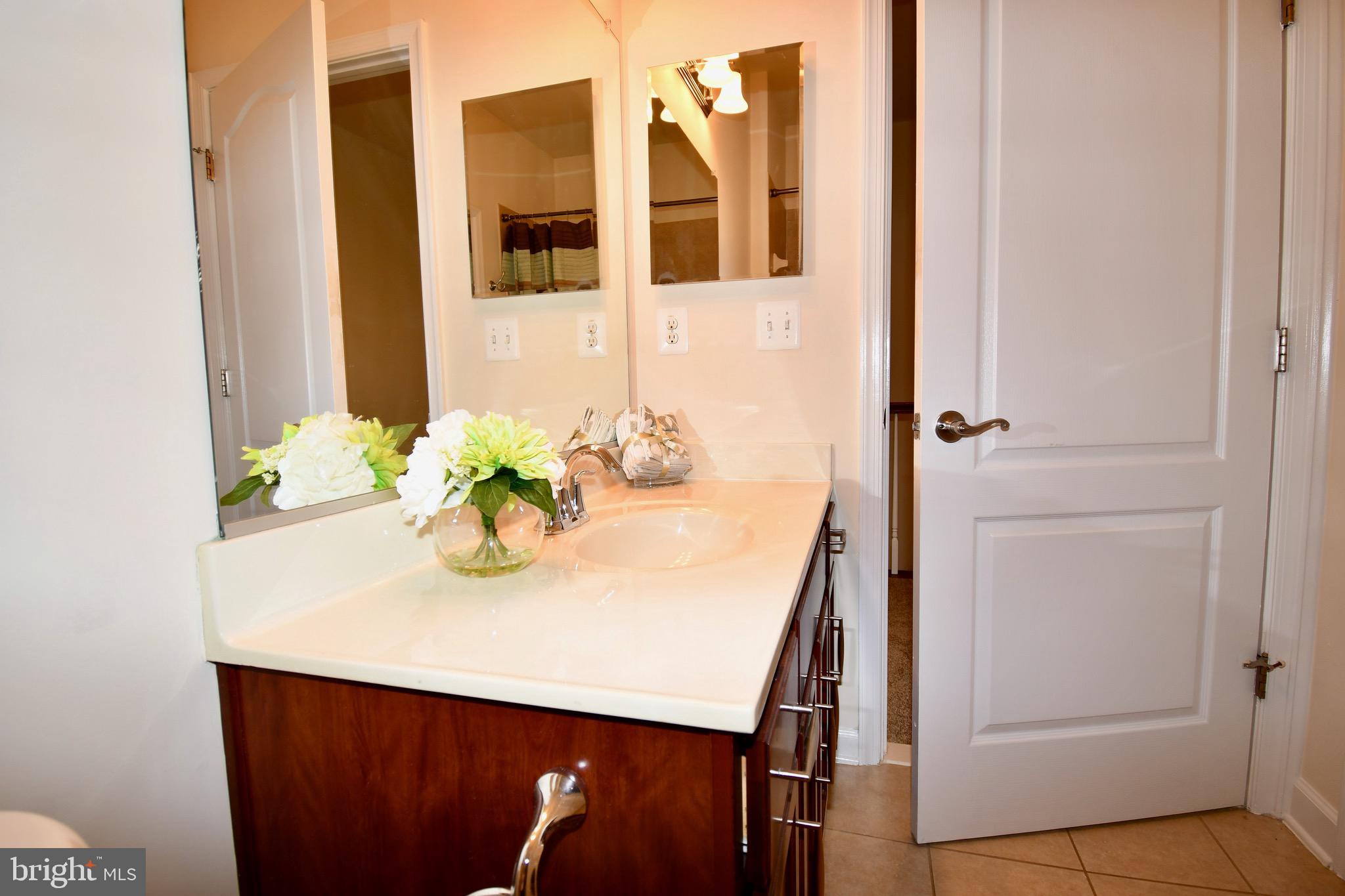 11665 Leesborough Circle Silver Spring, MD 20902 - Photo 56 of 82 a bathroom with a sink and a mirror