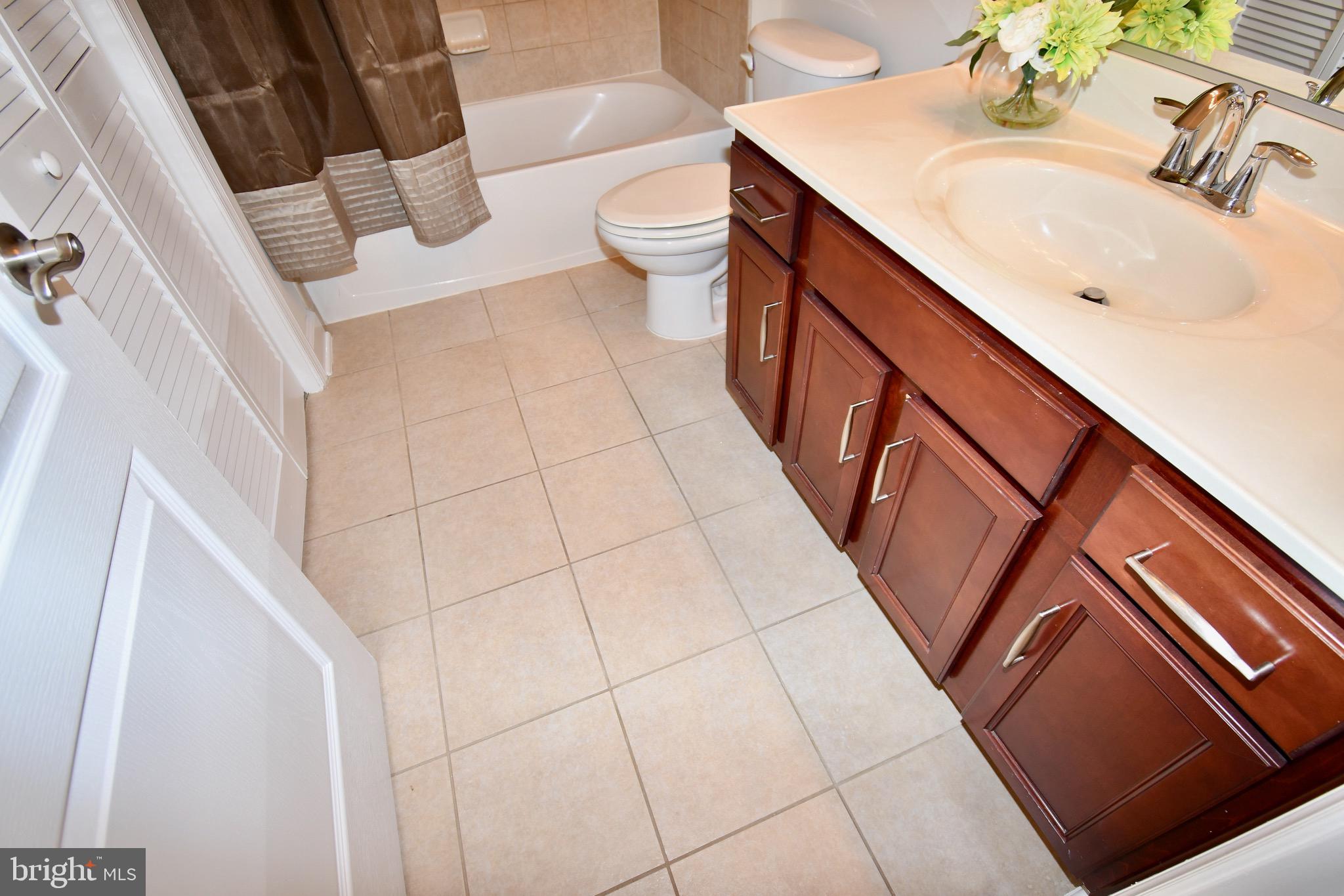 11665 Leesborough Circle Silver Spring, MD 20902 - Photo 57 of 82 a bathroom with a sink and a mirror