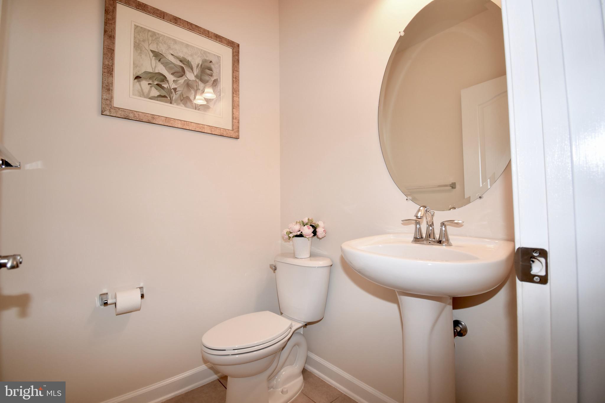 11665 Leesborough Circle Silver Spring, MD 20902 - Photo 75 of 82 a bathroom with a toilet sink and mirror