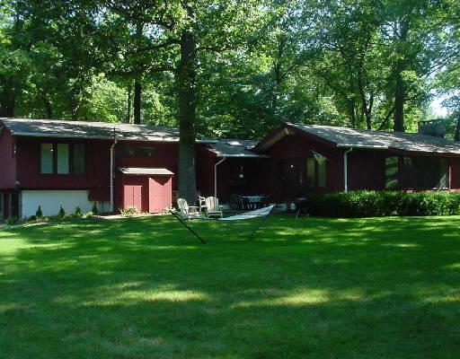 9 High Noon Road Weston, CT 06883 - Photo 1 of 1 a front view of house with yard and green space