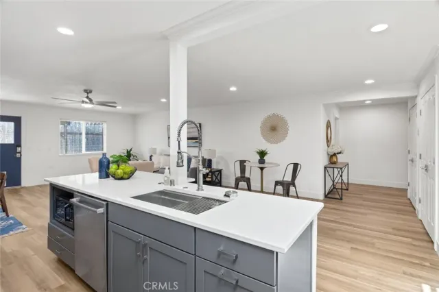 a kitchen with a sink a counter space and stainless steel appliances