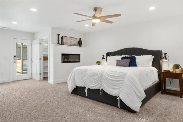 a spacious bedroom with a bed and a ceiling fan