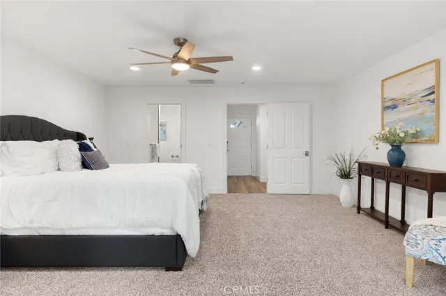 a bedroom with bed and a chandelier