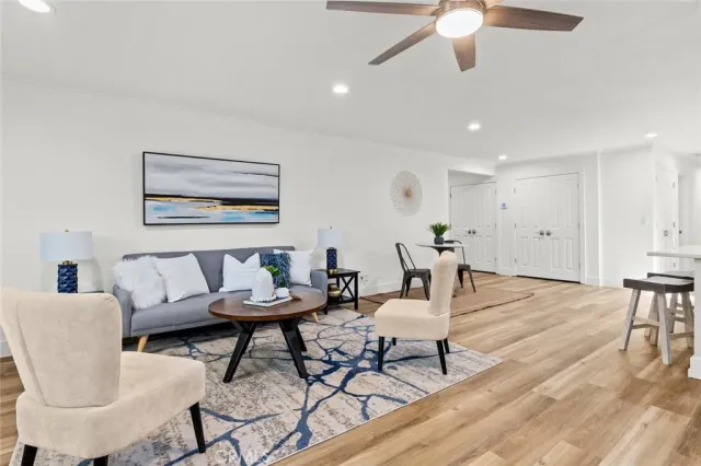 a living room with furniture and a wooden floor