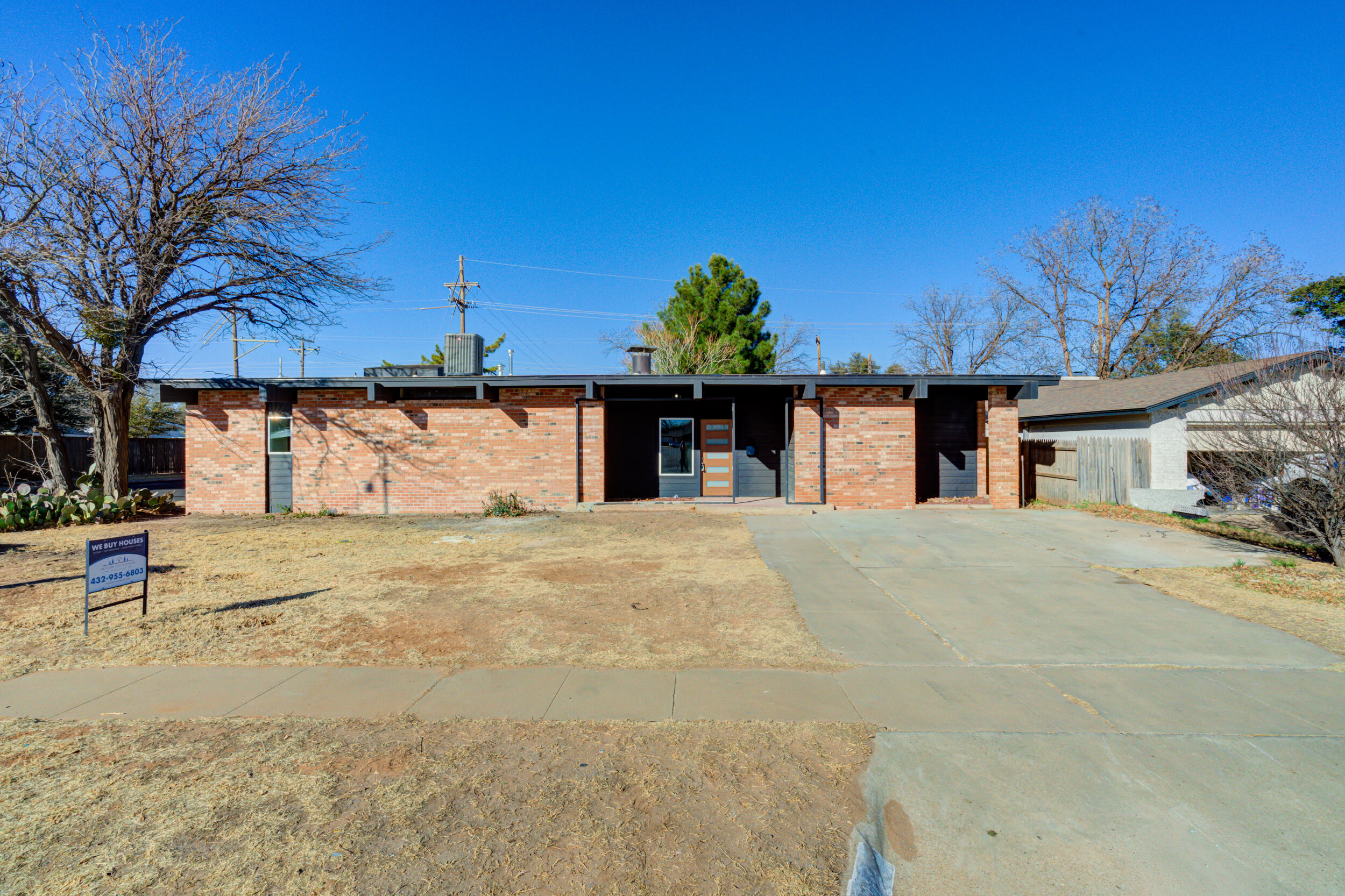 2218 58th Street Lubbock, TX 79412 - Photo 1 of 66 a front view of a house with a yard and garage