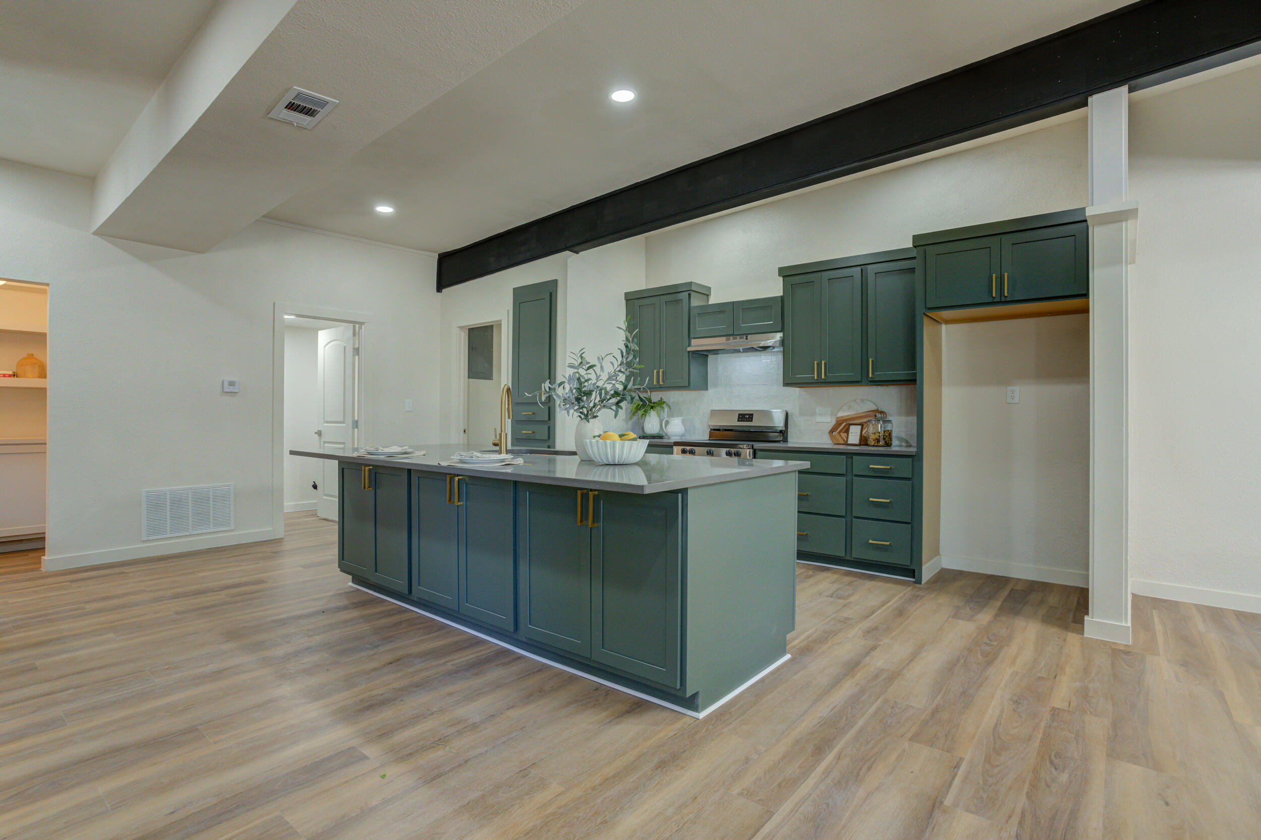 2218 58th Street Lubbock, TX 79412 - Photo 22 of 66 a kitchen with stainless steel appliances kitchen island granite countertop a refrigerator a sink and a stove