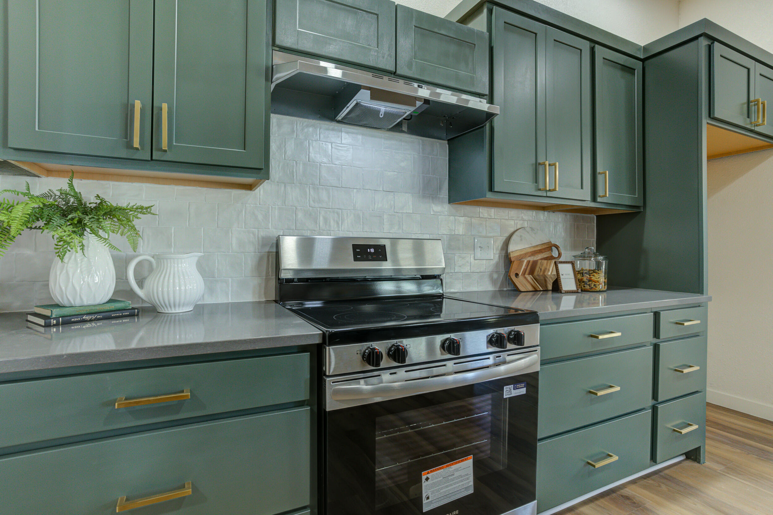 2218 58th Street Lubbock, TX 79412 - Photo 23 of 66 a kitchen with stainless steel appliances granite countertop a sink a stove and cabinets