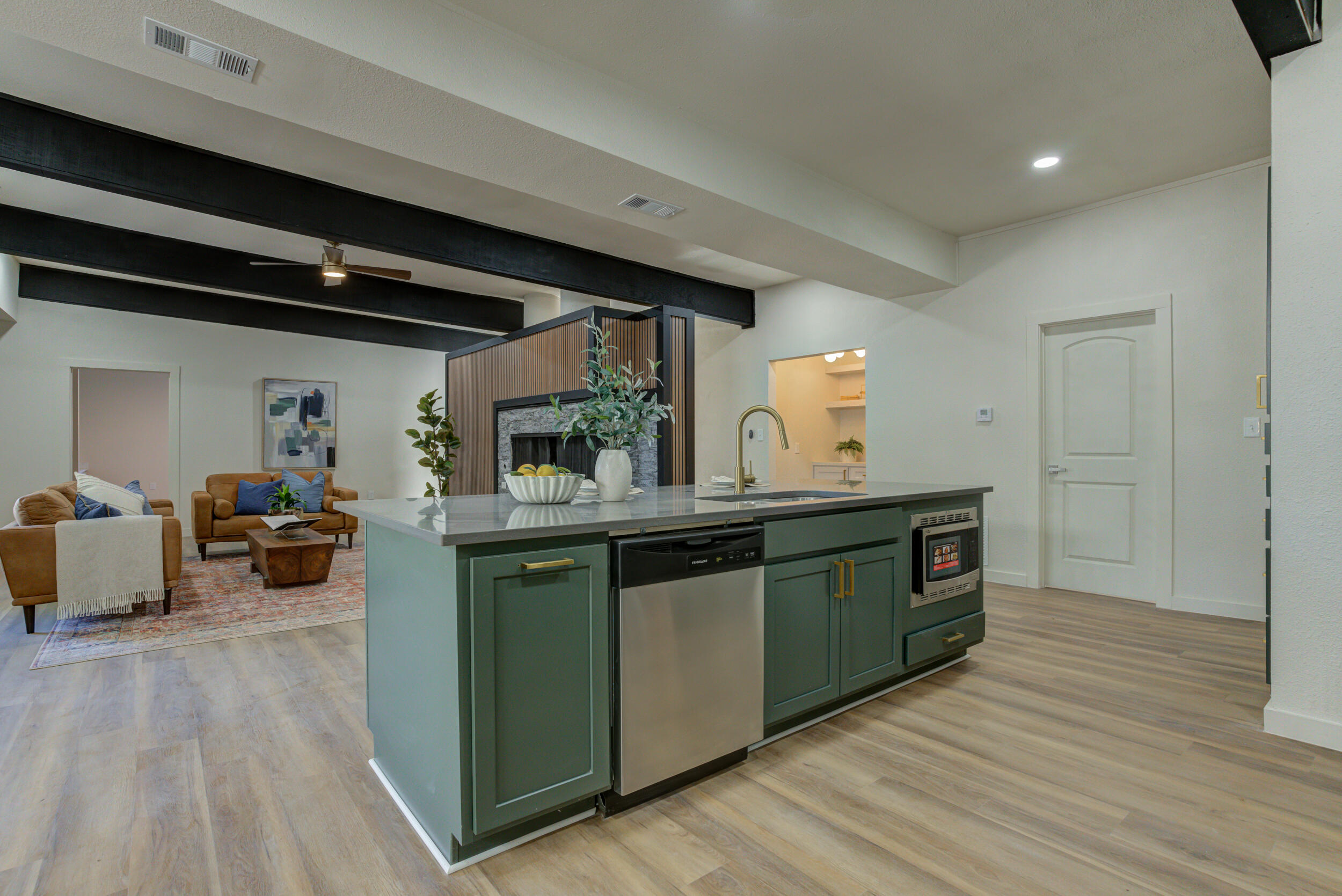 2218 58th Street Lubbock, TX 79412 - Photo 25 of 66 a kitchen with granite countertop a stove and a wooden floors