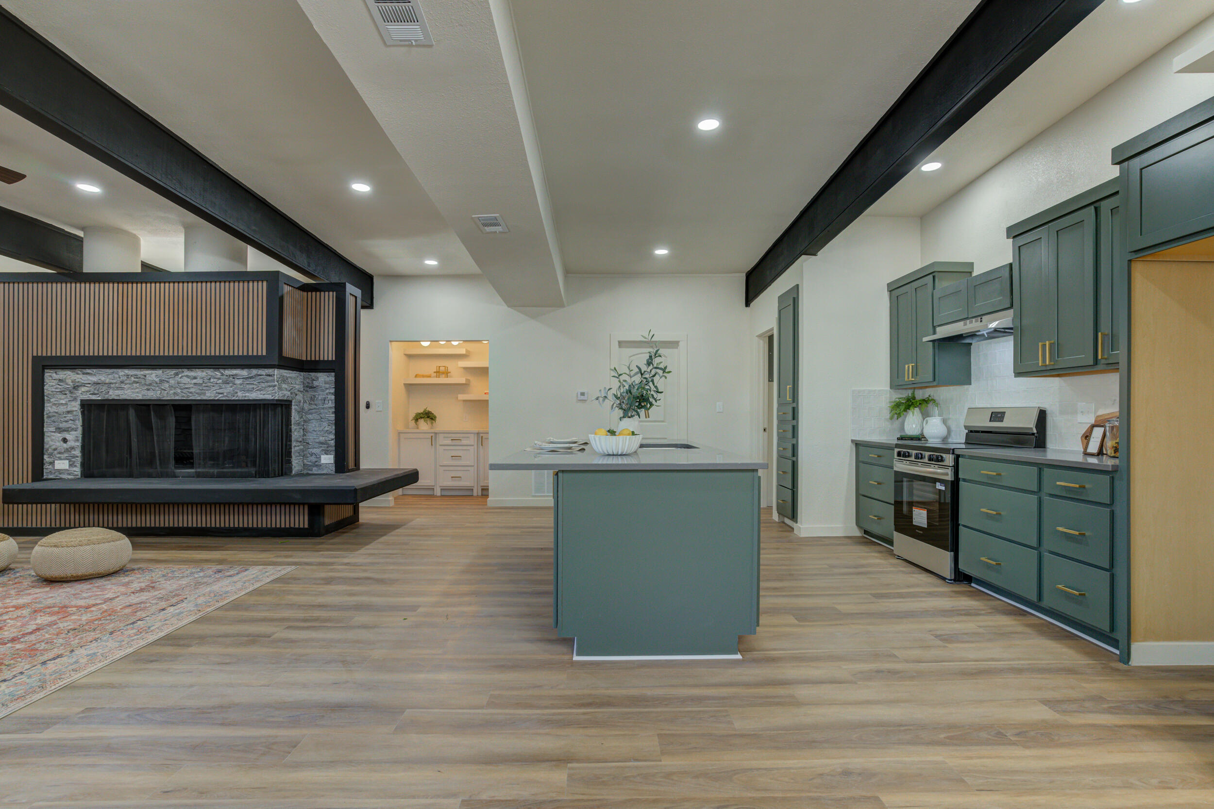 2218 58th Street Lubbock, TX 79412 - Photo 27 of 66 a kitchen with furniture and a fireplace