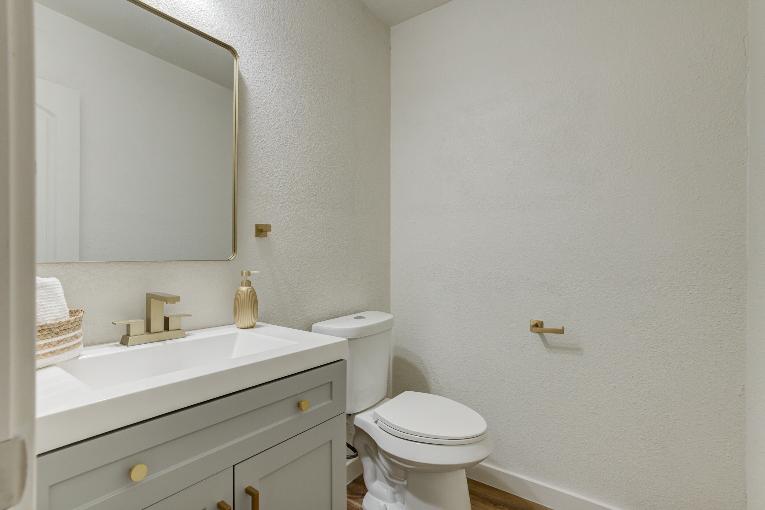 2218 58th Street Lubbock, TX 79412 - Photo 39 of 66 a bathroom with a sink toilet and a mirror