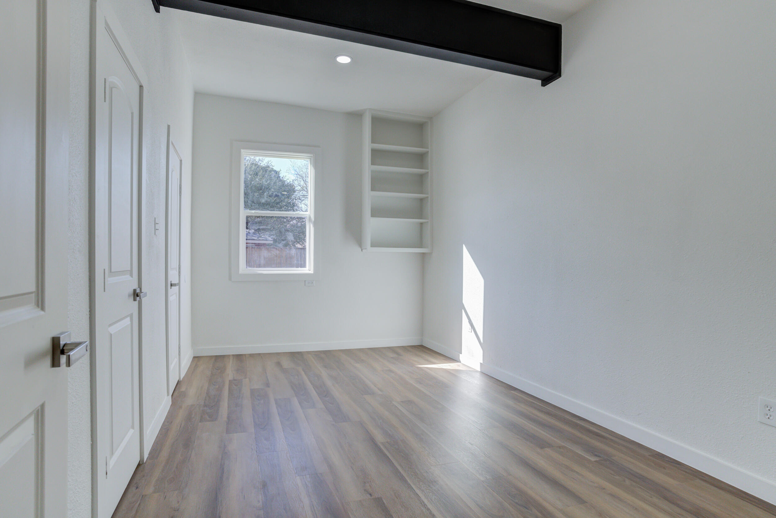 2218 58th Street Lubbock, TX 79412 - Photo 44 of 66 an empty room with wooden floor and windows