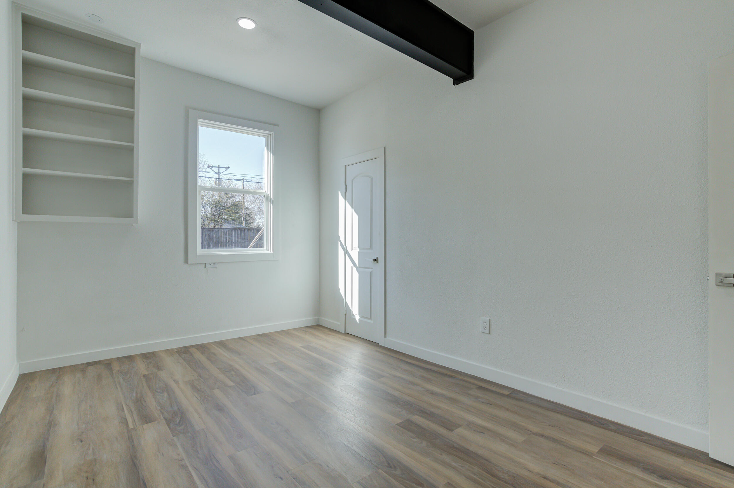 2218 58th Street Lubbock, TX 79412 - Photo 47 of 66 an empty room with wooden floor and windows