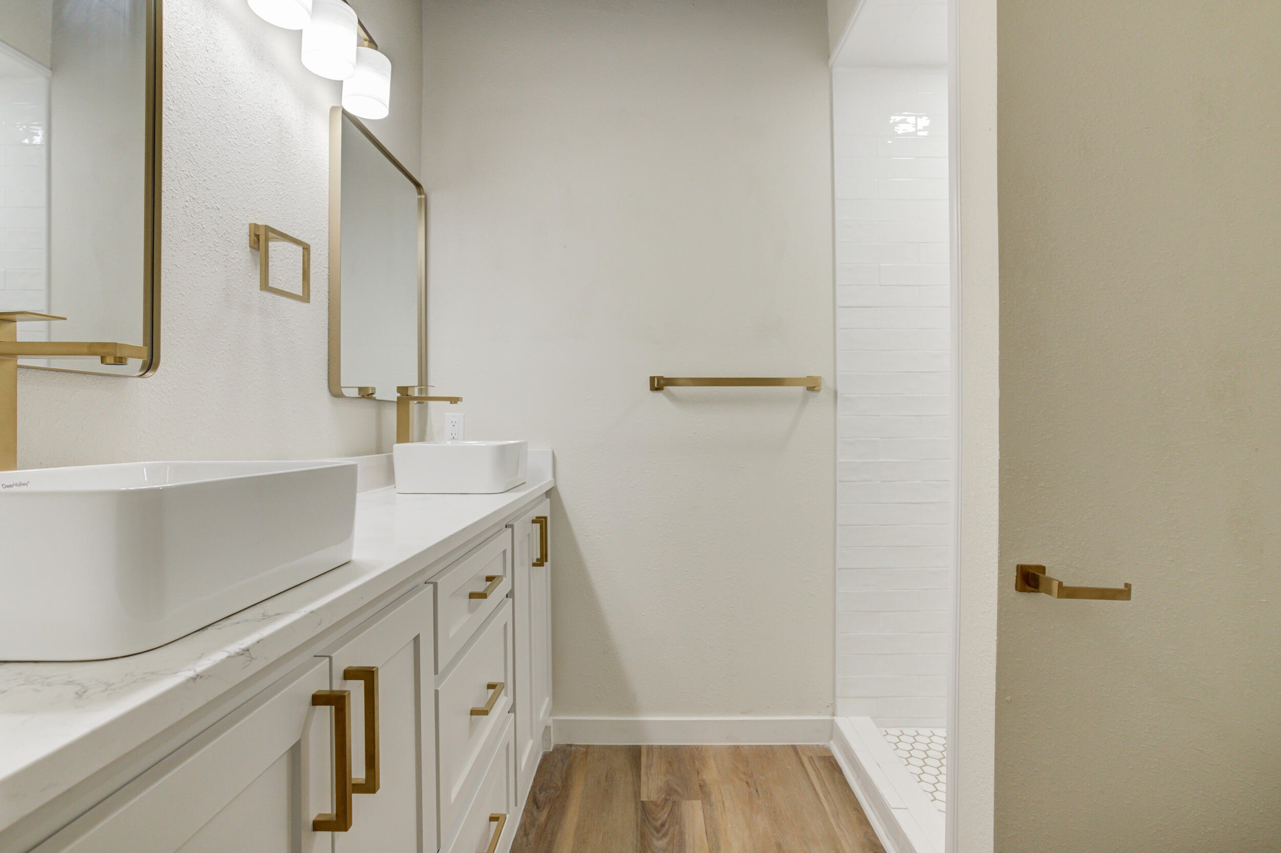 2218 58th Street Lubbock, TX 79412 - Photo 48 of 66 a bathroom with a sink and a mirror