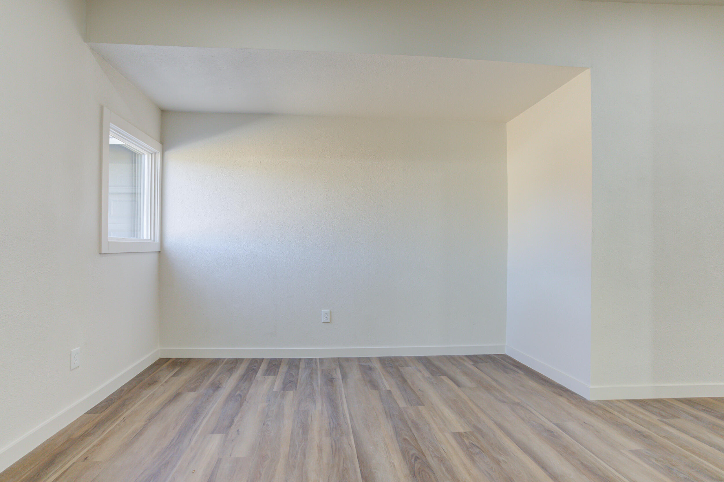 2218 58th Street Lubbock, TX 79412 - Photo 49 of 66 a view of an empty room with wooden floor and a window