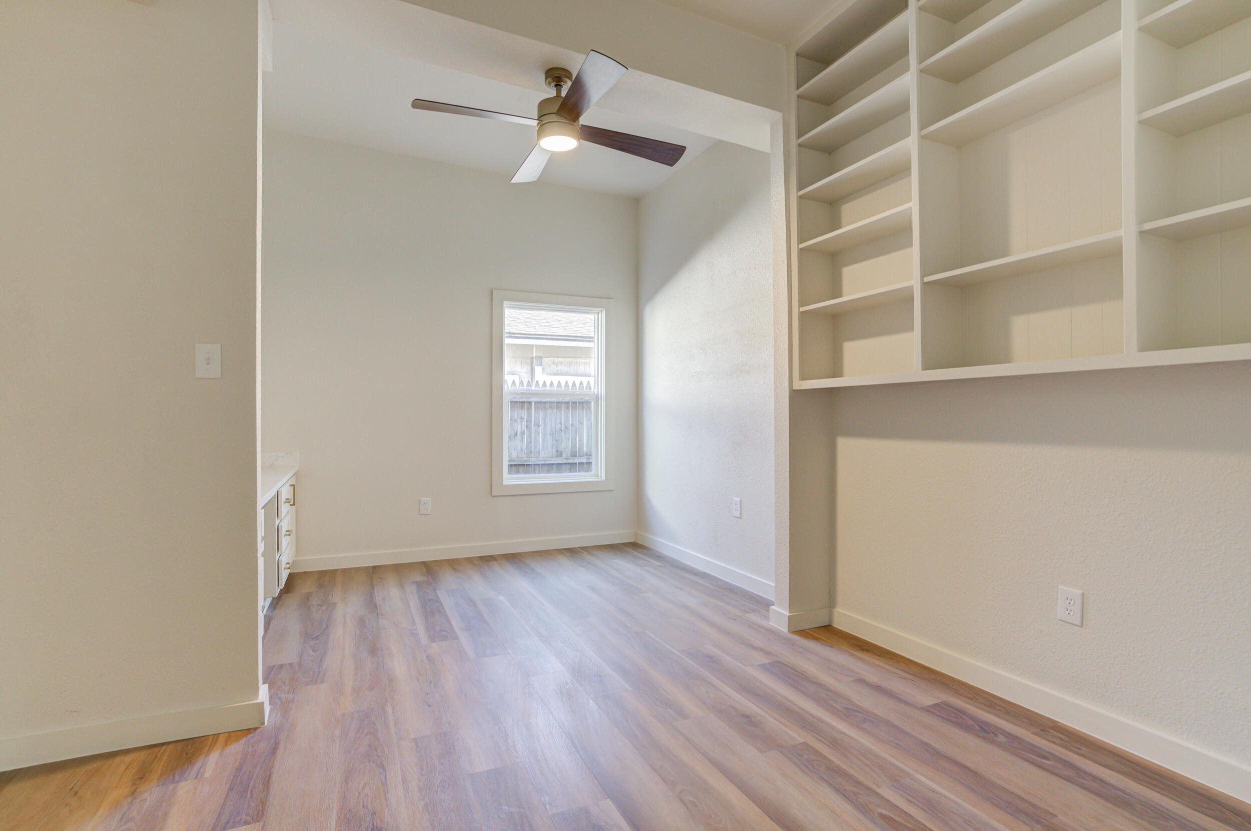 2218 58th Street Lubbock, TX 79412 - Photo 54 of 66 an empty room with cabinet and windows