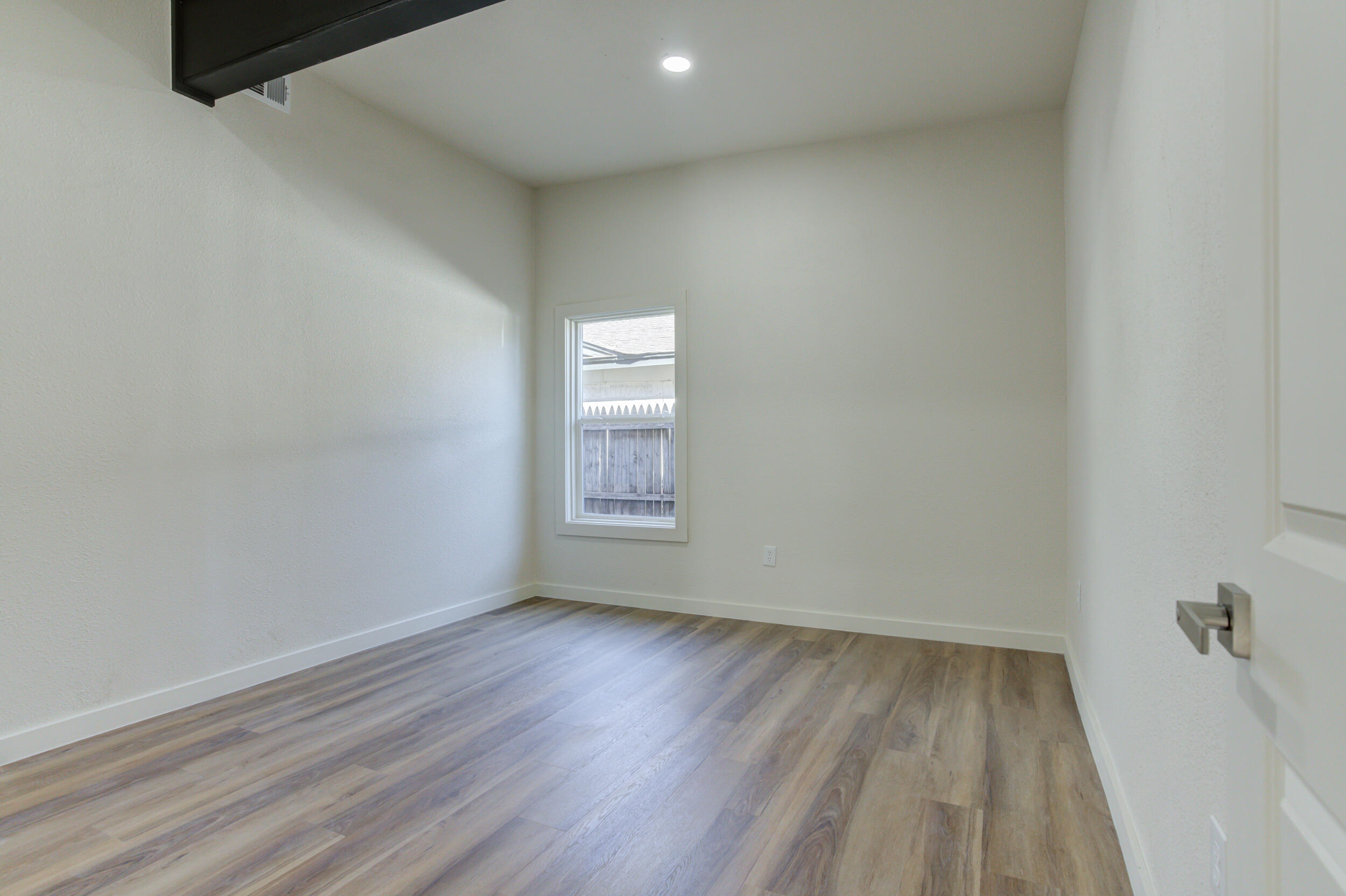 2218 58th Street Lubbock, TX 79412 - Photo 55 of 66 a view of room with window and hardwood floor