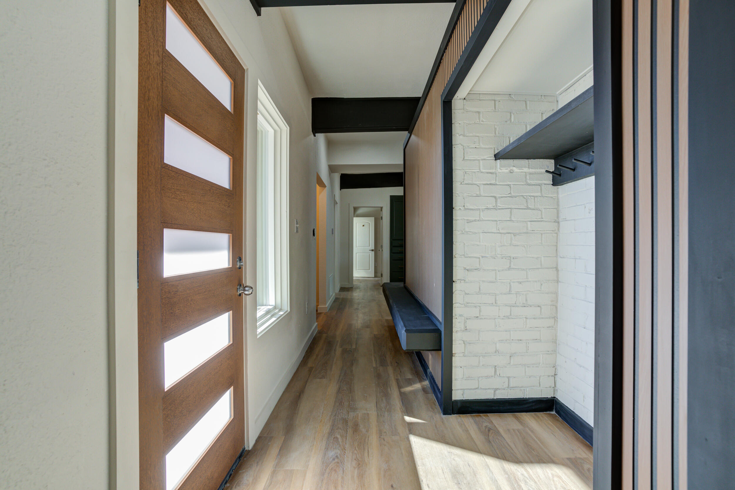 2218 58th Street Lubbock, TX 79412 - Photo 9 of 66 a view of a hallway with wooden floor and staircase