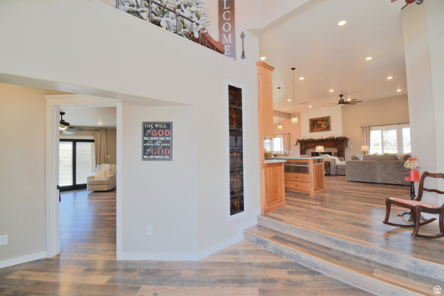 656 South Bullion Canyon Road Marysvale, UT 84750 - Photo 6 of 57 Living room with ceiling fan, recessed lighting, a fireplace, light wood-style floors, and healthy amount of natural light. Featuring built in ladder leading to "reading nook".