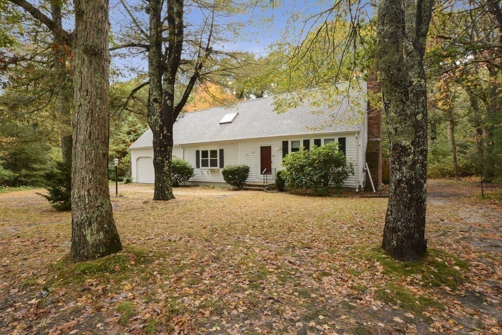499 Skunknet Road Barnstable, MA 02632 - Photo 2 of 16 a yellow house with a tree in front of it