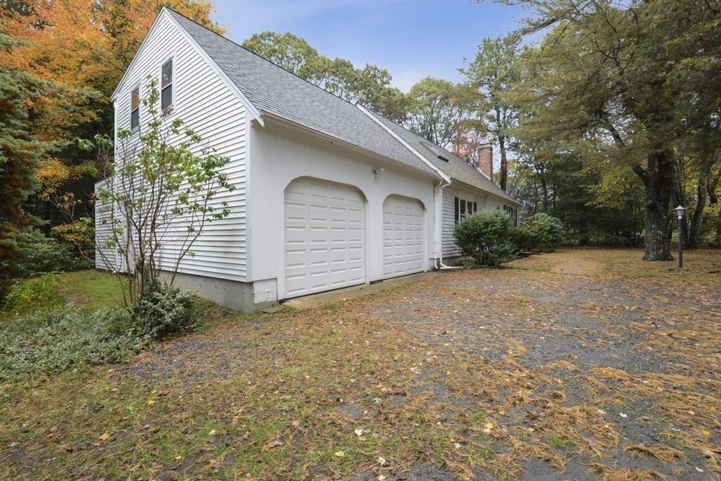 499 Skunknet Road Barnstable, MA 02632 - Photo 3 of 16 a view of a house with a yard and garage