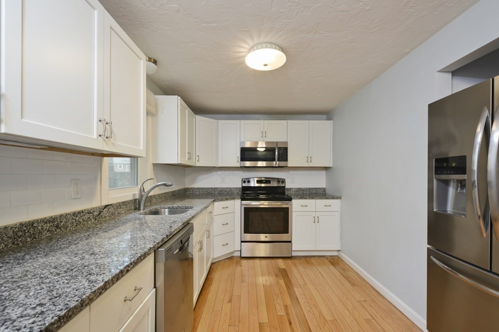 499 Skunknet Road Barnstable, MA 02632 - Photo 5 of 16 a kitchen with a sink stove and refrigerator