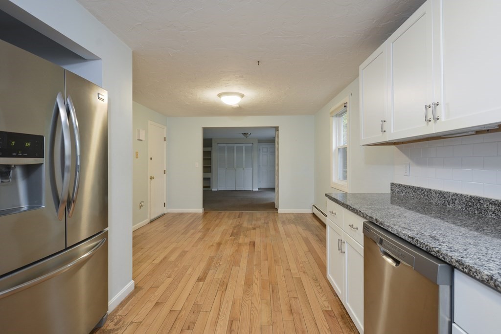 499 Skunknet Road Barnstable, MA 02632 - Photo 6 of 16 a kitchen with granite countertop a refrigerator and a sink