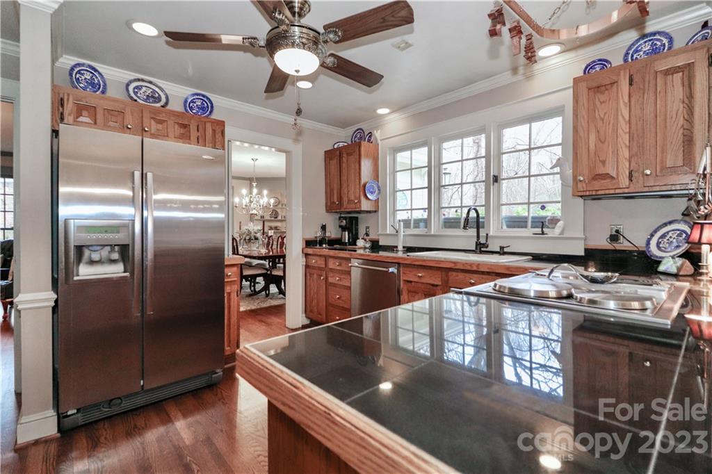 415 Westchester Road Statesville, NC 28625 - Photo 18 of 48 a kitchen with stainless steel appliances granite countertop a refrigerator a sink dishwasher a stove and white countertops with wooden floor