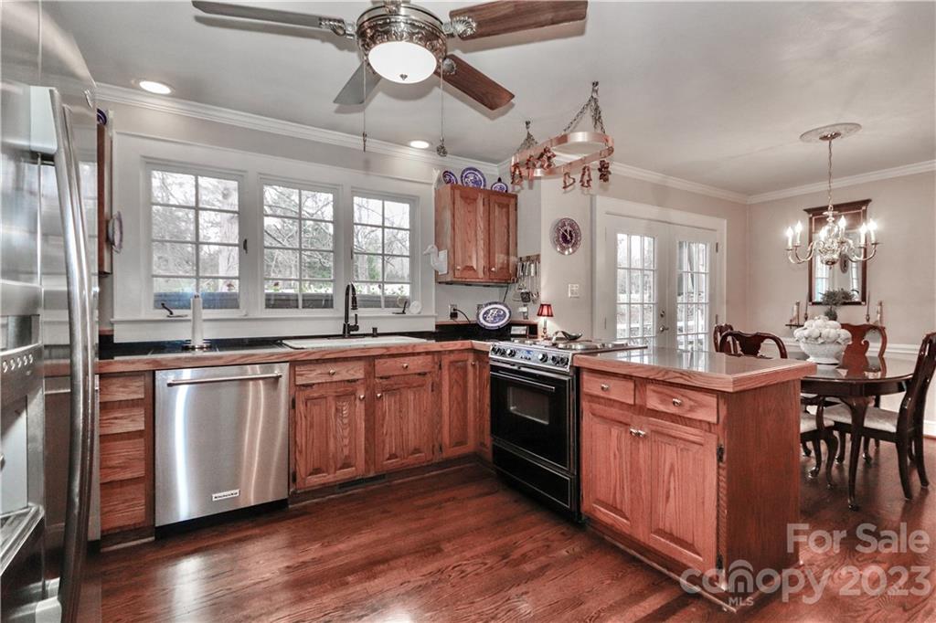 415 Westchester Road Statesville, NC 28625 - Photo 22 of 48 a kitchen with stainless steel appliances granite countertop a sink a stove and a refrigerator