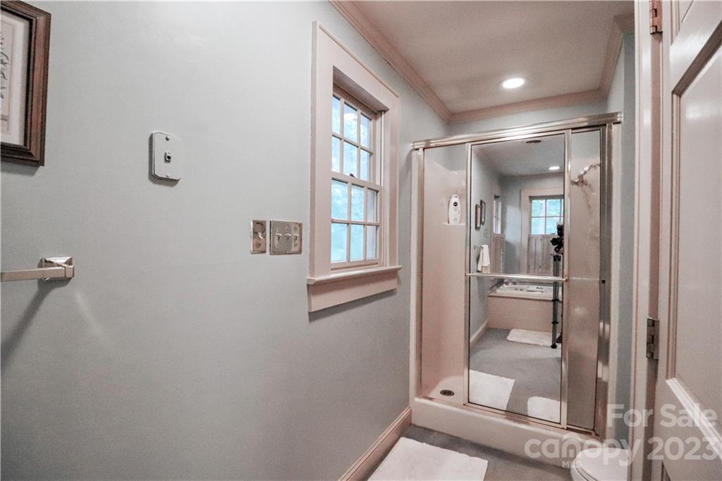 415 Westchester Road Statesville, NC 28625 - Photo 25 of 48 a bathroom with a glass shower door and a window