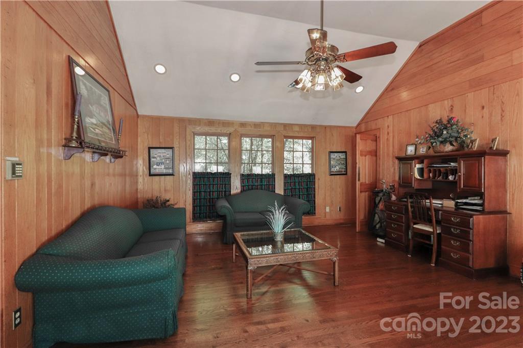 415 Westchester Road Statesville, NC 28625 - Photo 27 of 48 a living room with furniture a chandelier and a dining table