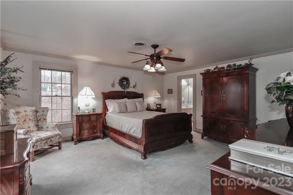 415 Westchester Road Statesville, NC 28625 - Photo 30 of 48 a bedroom with a bed and a chandelier
