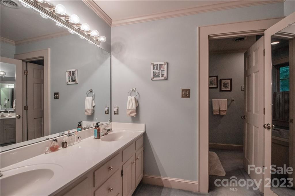 415 Westchester Road Statesville, NC 28625 - Photo 33 of 48 a bathroom with a double vanity sink and a mirror