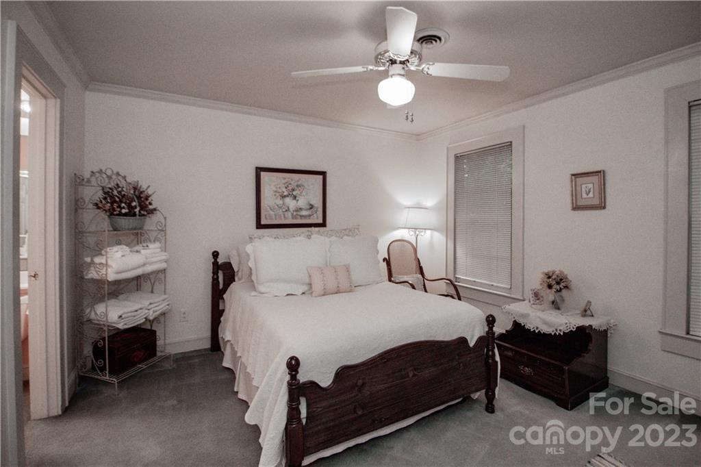 415 Westchester Road Statesville, NC 28625 - Photo 35 of 48 a bedroom with a bed and a chandelier