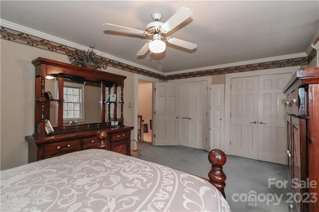 415 Westchester Road Statesville, NC 28625 - Photo 37 of 48 a bedroom with a bed and a chandelier