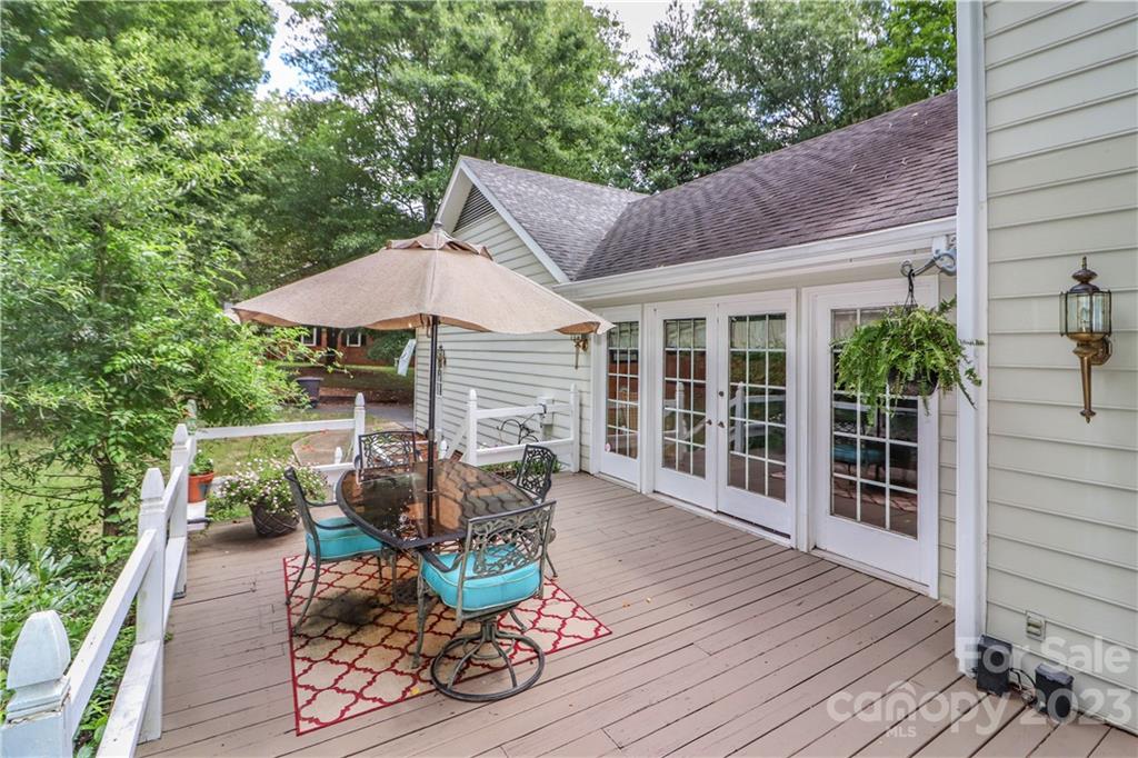 415 Westchester Road Statesville, NC 28625 - Photo 45 of 48 a view of a patio with table and chairs potted plants with wooden floor