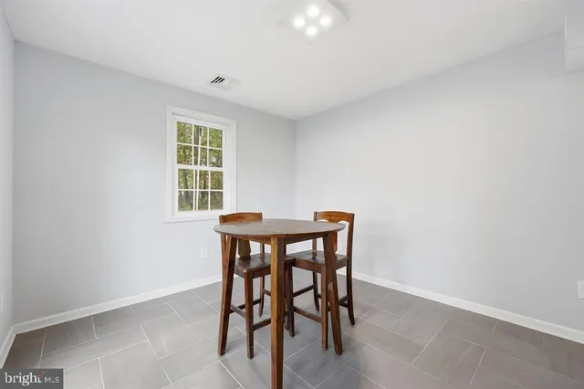 a view of a dining room with furniture and window