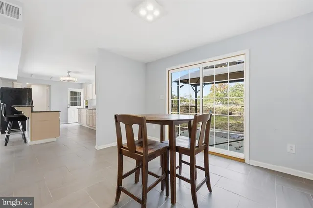 a dining room with furniture and wooden floor