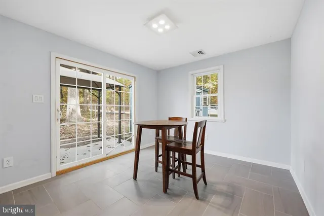 a view of a room with furniture and a window