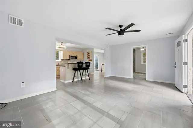 a view of a livingroom with furniture and ceiling fan