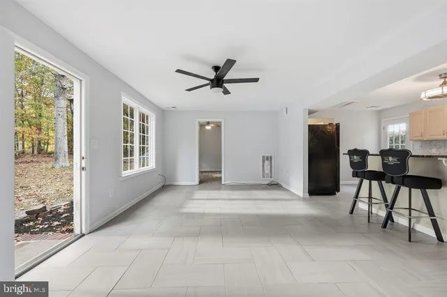 a view of a livingroom with furniture and a ceiling fan