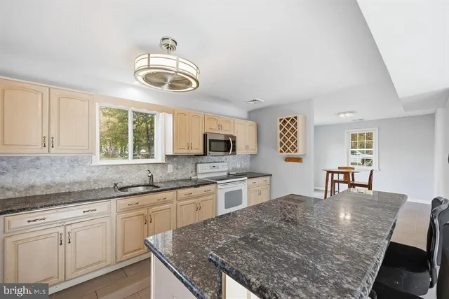 a kitchen with a stove and a sink