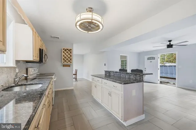 a kitchen with stainless steel appliances granite countertop a sink and stove