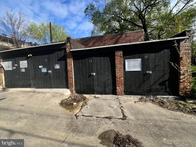 a front view of a house with a tree