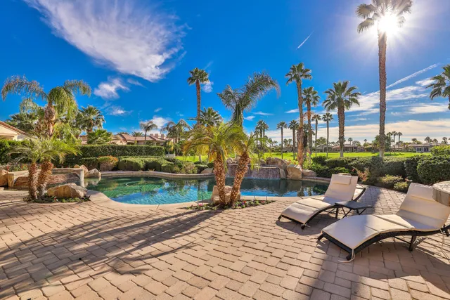 a view of a patio with couches table and chairs and potted plants