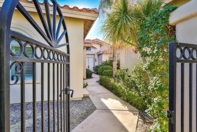 a front view of a house with swimming pool and a yard